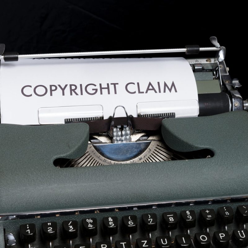typewriter with paper marking 'copyright claim' intellectual property rights (IP), Patent, Trademark, Trade Secrets.